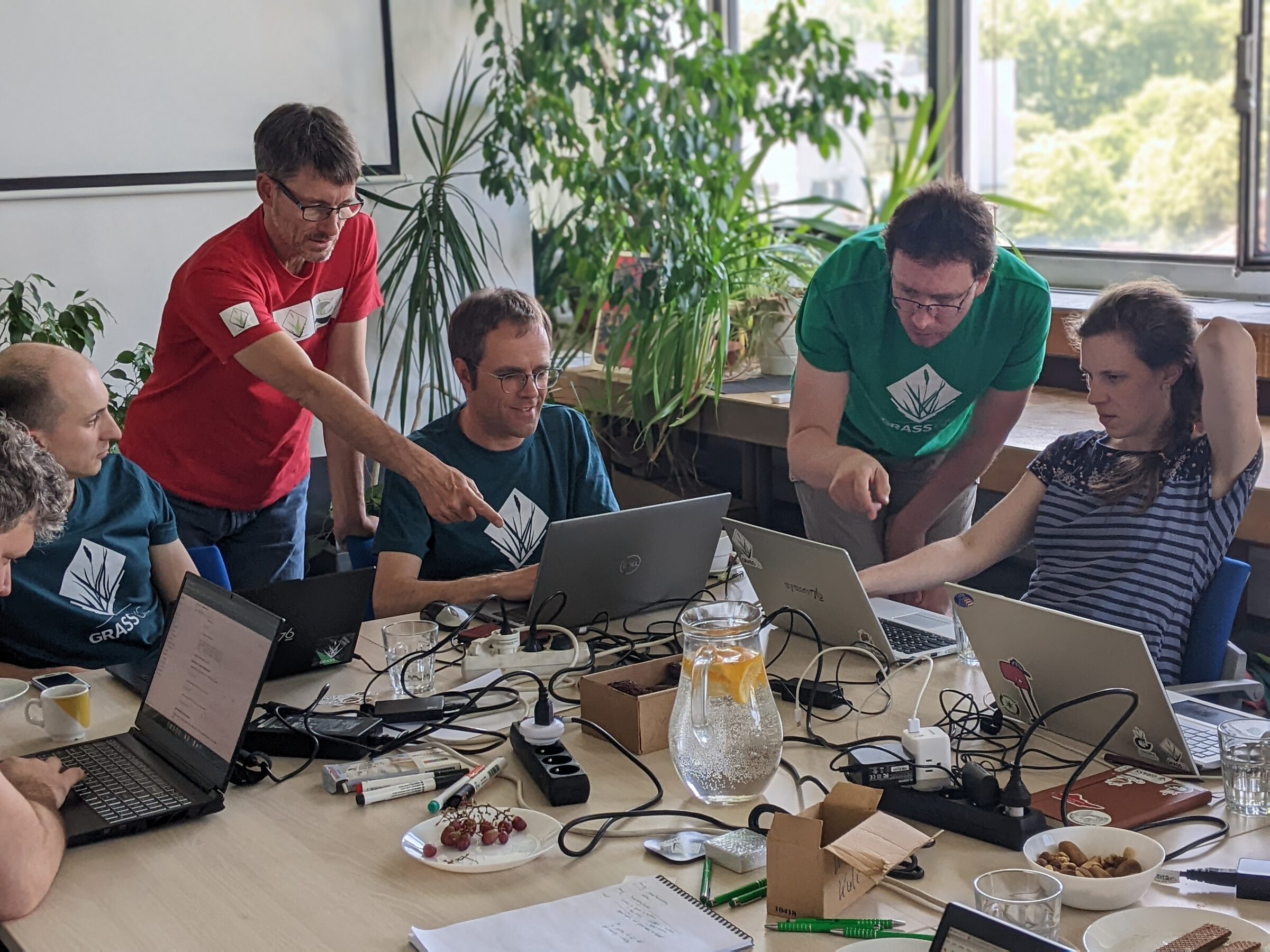 GRASS contributors collaborating around laptops at the 2023 GRASS Community Meeting in Prague